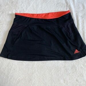 Ladies Adidas golf or tennis skirt size medium black with orange accents